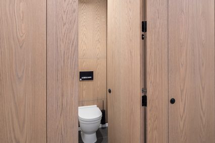 Floor to ceiling cubicle system with black PVD ironmongery